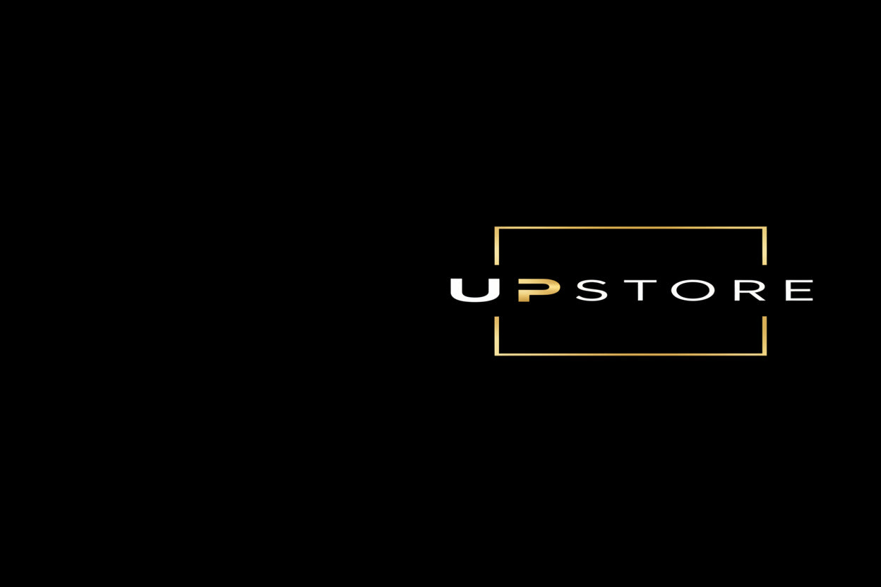UPSTORE logo centered on a black background, with white and gold lettering and a thin gold rectangular outline.
